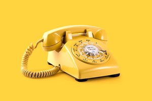A yellow dial telephone